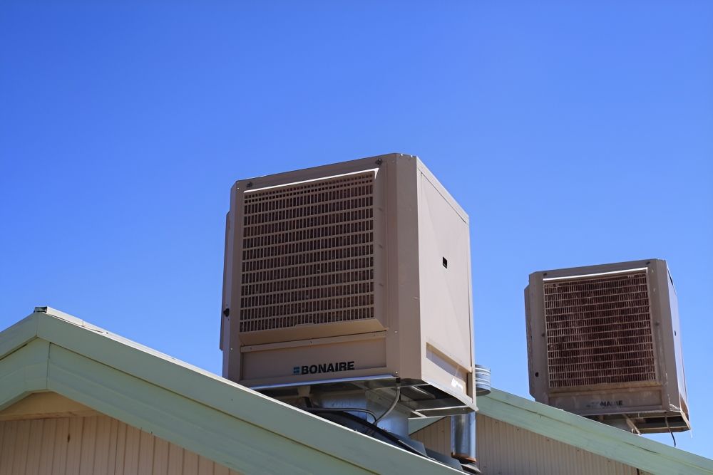 Two Air Conditioners Are on the Roof of a Building —​ Centre Evap & Home Maintenance Services in Ciccone, NT