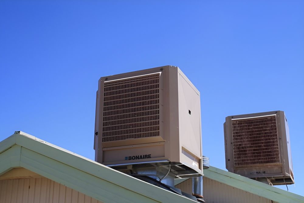 Two Air Conditioners Are on the Roof of a Building —​ Centre Evap & Home Maintenance Services in Ciccone, NT