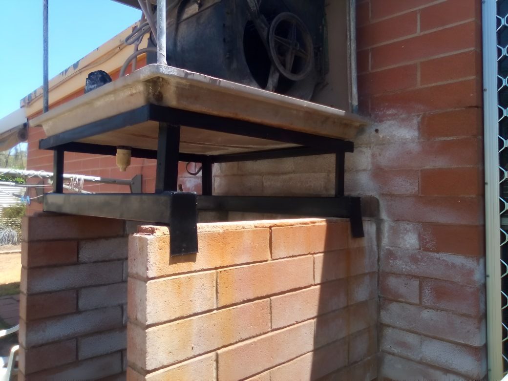 A Brick Wall With a Shelf on Top of It —​ Centre Evap & Home Maintenance Services in Ciccone, NT