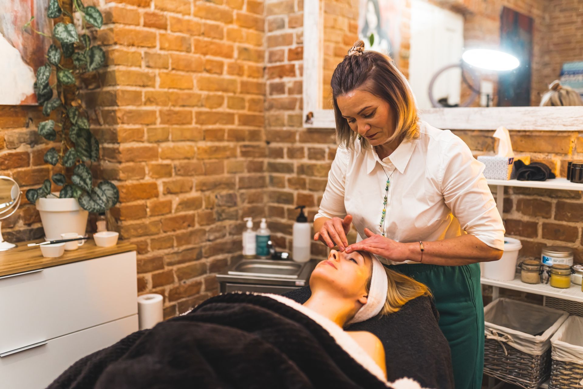 A woman is getting a facial treatment in a beauty salon.
