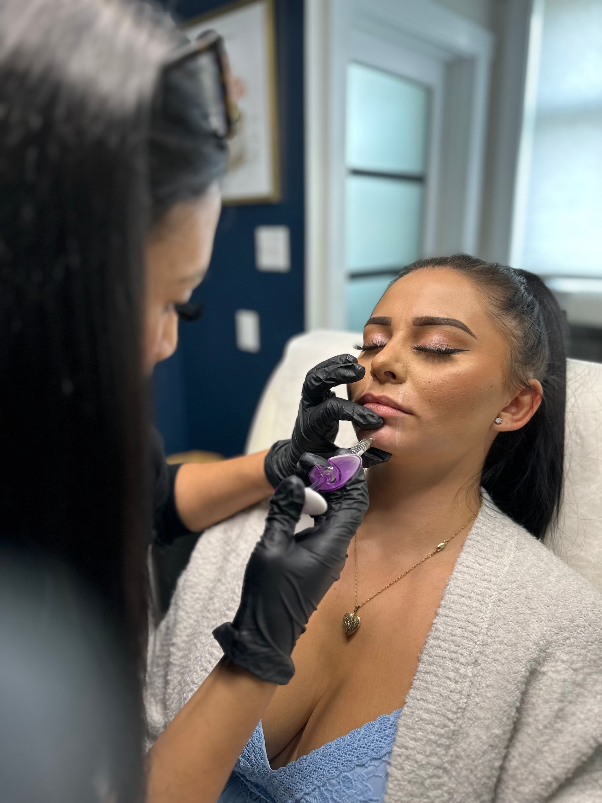 a woman is getting a botox treatment on her lips .
