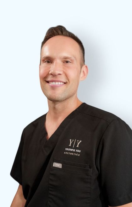 A man wearing a black scrub top with the letter y on it