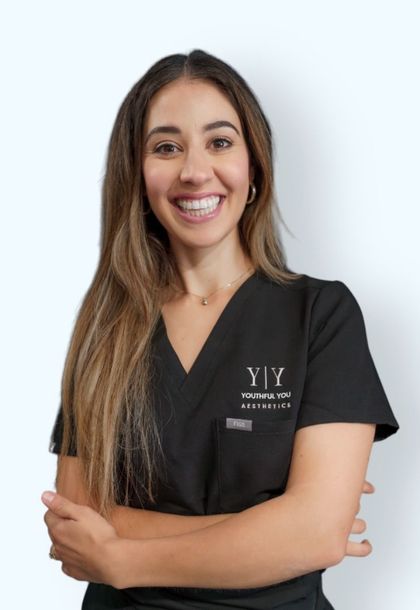 A woman wearing a black scrub top with the word yiy on it