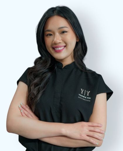 A woman wearing a black shirt that says ' y'y ' on it