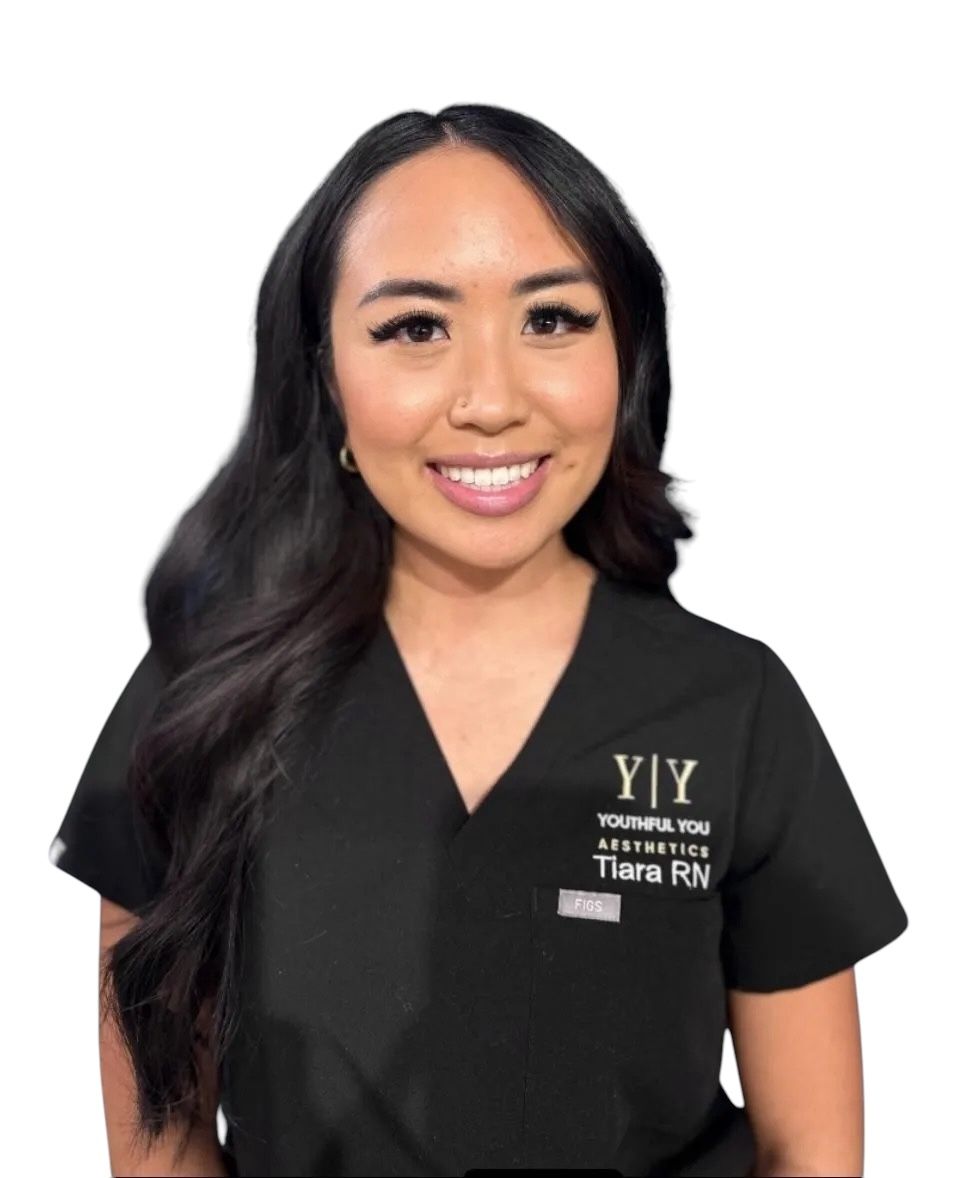 A woman wearing a black scrub top that says ' y / y ' on it