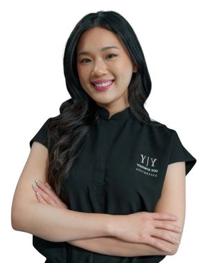 A woman wearing a black shirt that says ' y'y ' on it