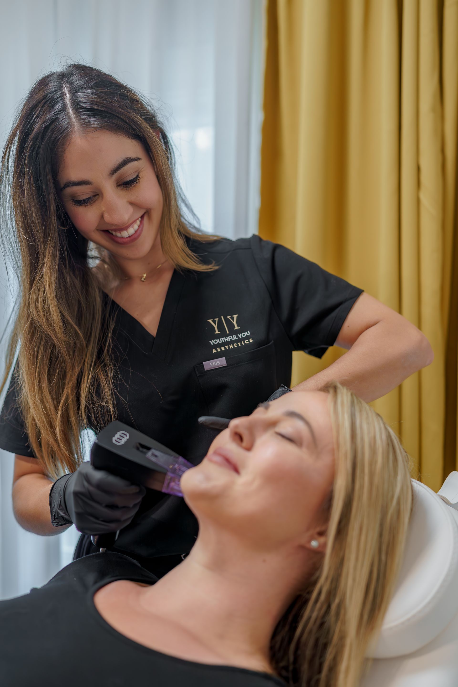 woman receiving microneedling treatment