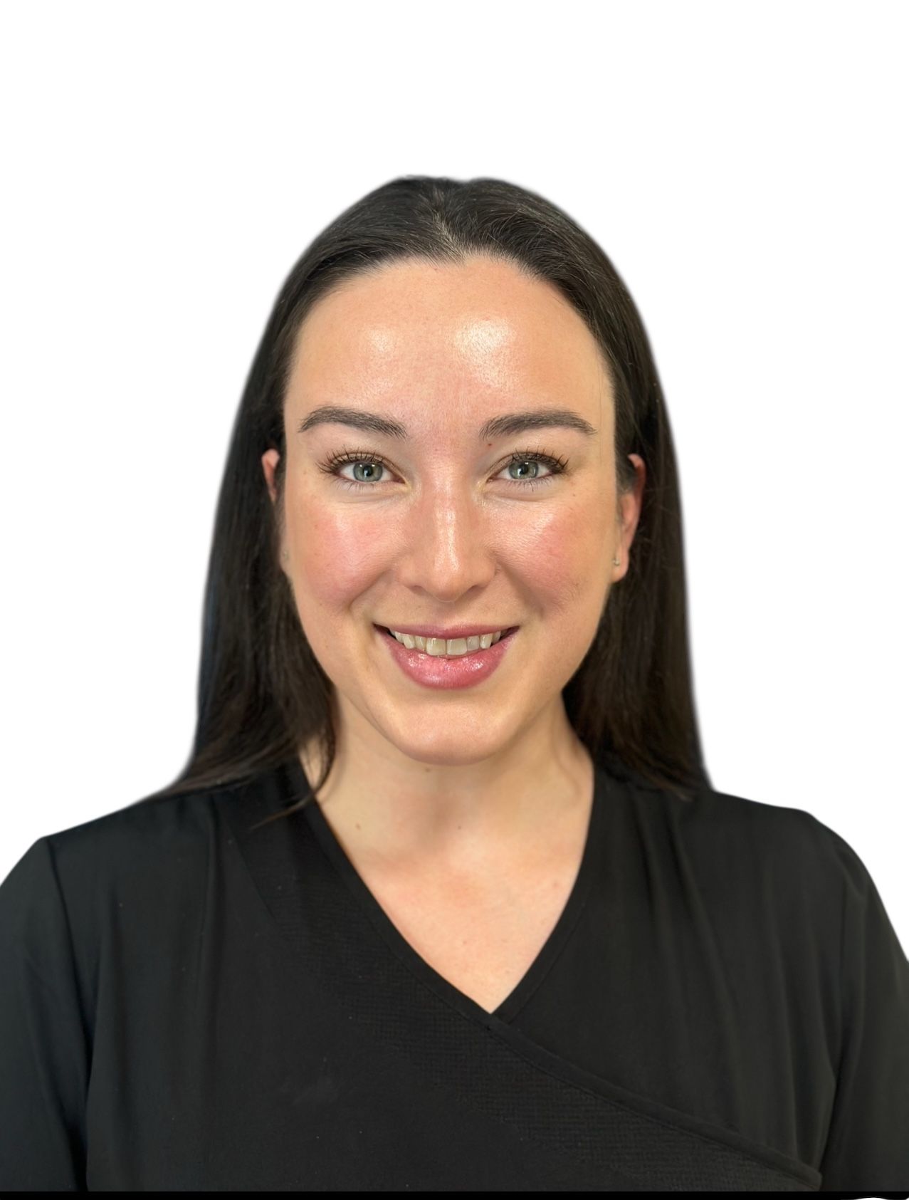 A woman in a black scrub top is smiling for the camera.