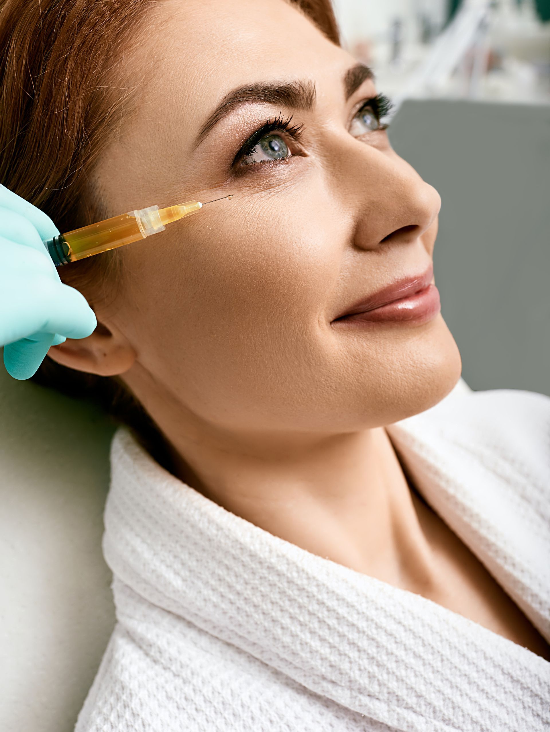 A woman is getting an injection in her eye.