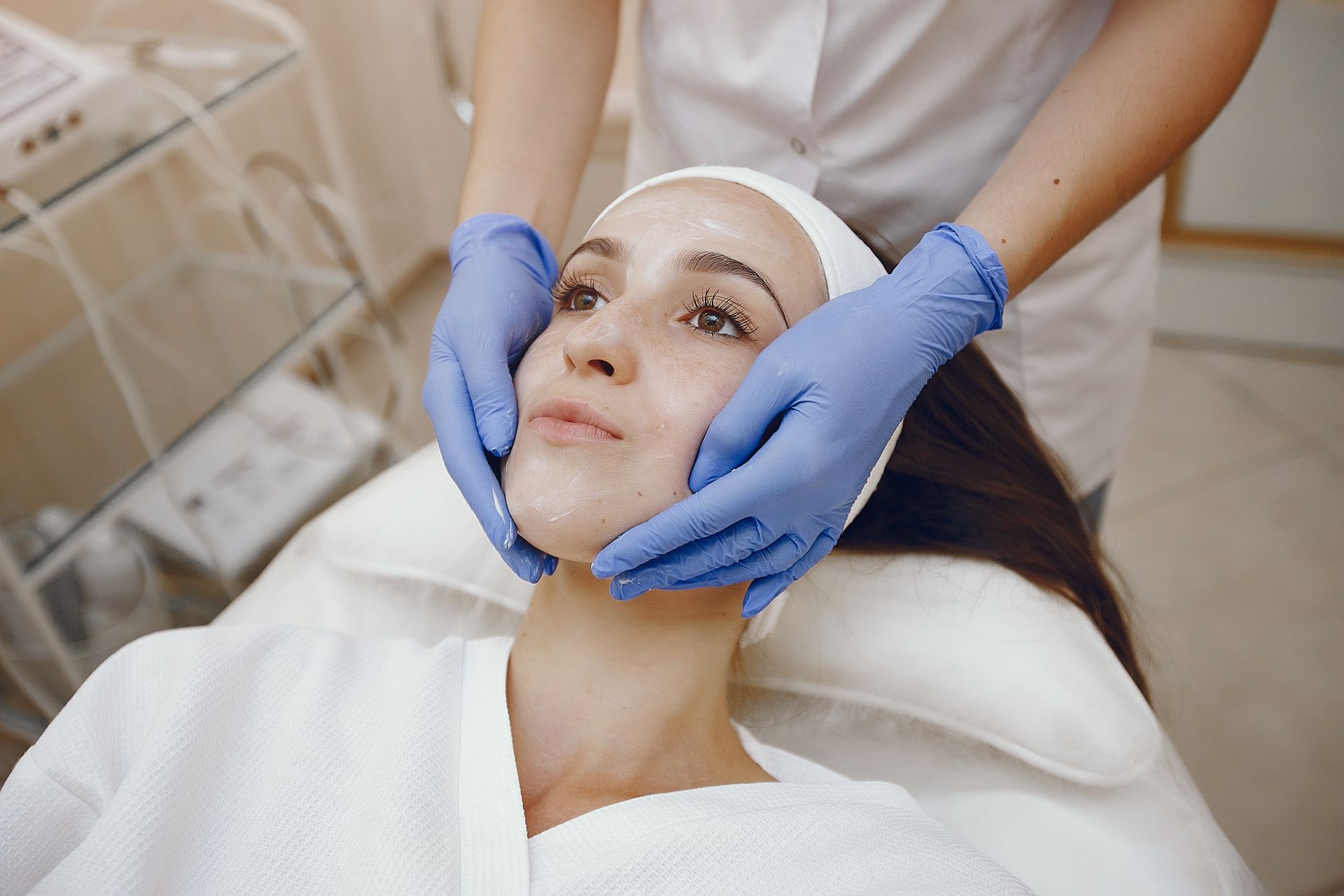 A woman is getting a facial treatment at a beauty salon.