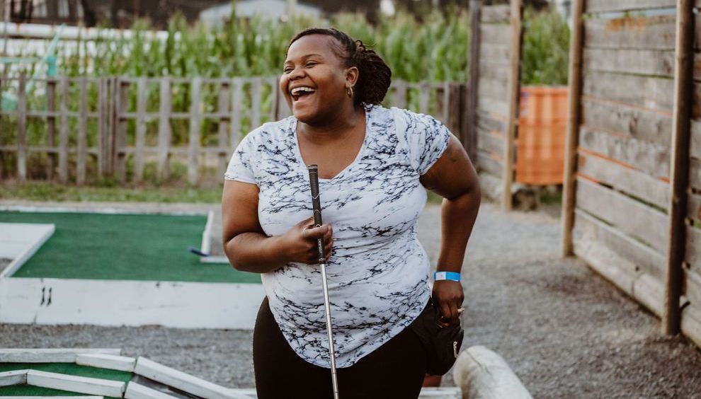 A group of people are playing mini golf at river city adventure park