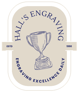 Logo for Hall's Engraving: cream-colored badge with a trophy illustration and navy blue text. 