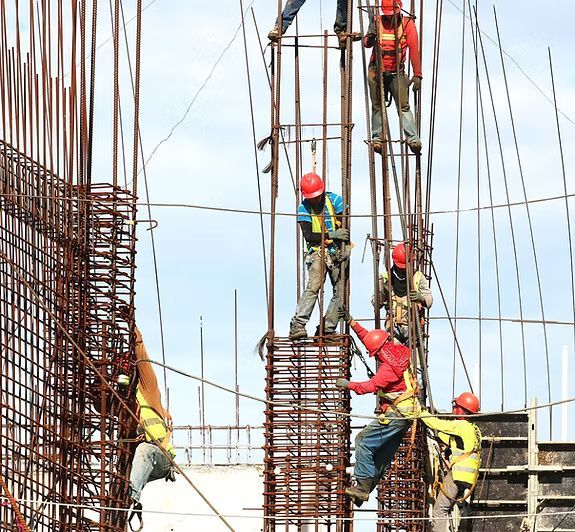 A group of construction workers are working on a building.