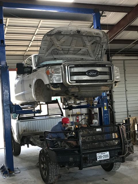 Diesel Repair — Mechanic Pouring Diesel on Engine in New Braunfels, TX