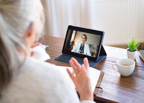 Senior Woman Having Video Call With Doctor — Lexington, KY — Cognitive Therapy and Mindfulness Practices