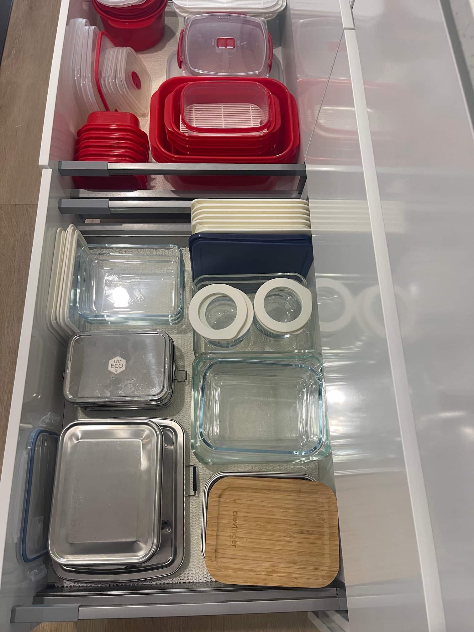 Drawer organised with food storage containers.
