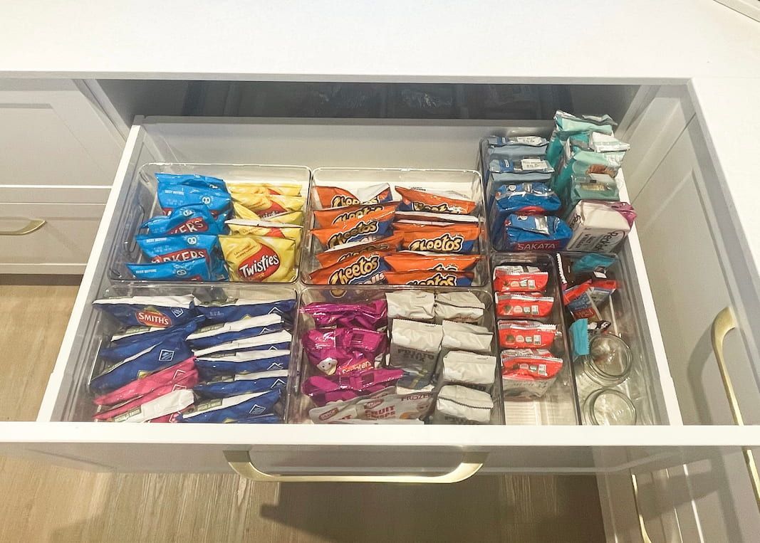 A drawer filled with organised snack bags and containers.