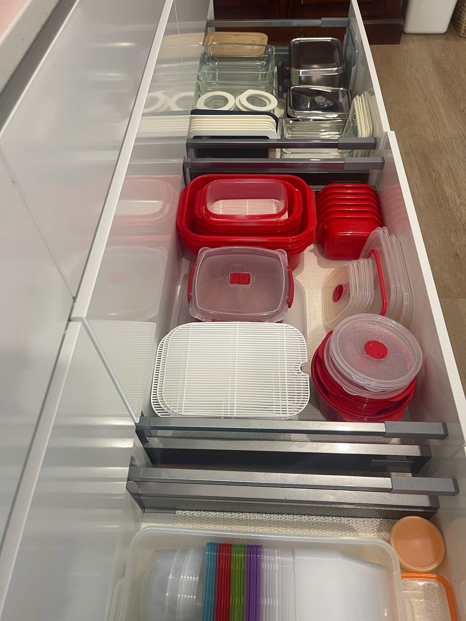 A drawer filled with organised food storage containers.