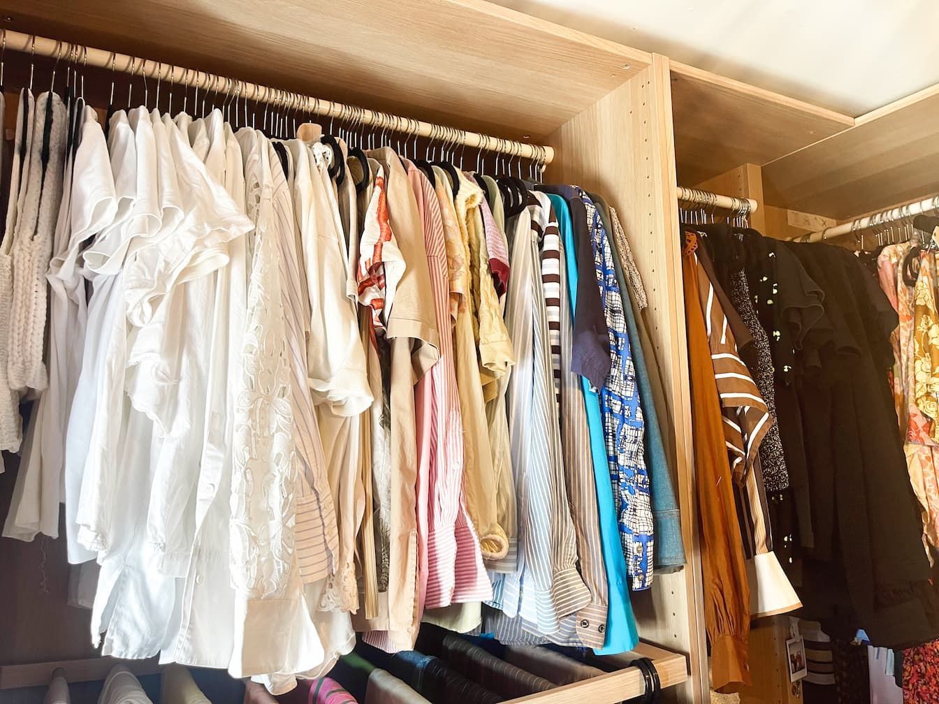 An organised cupboard with shirts