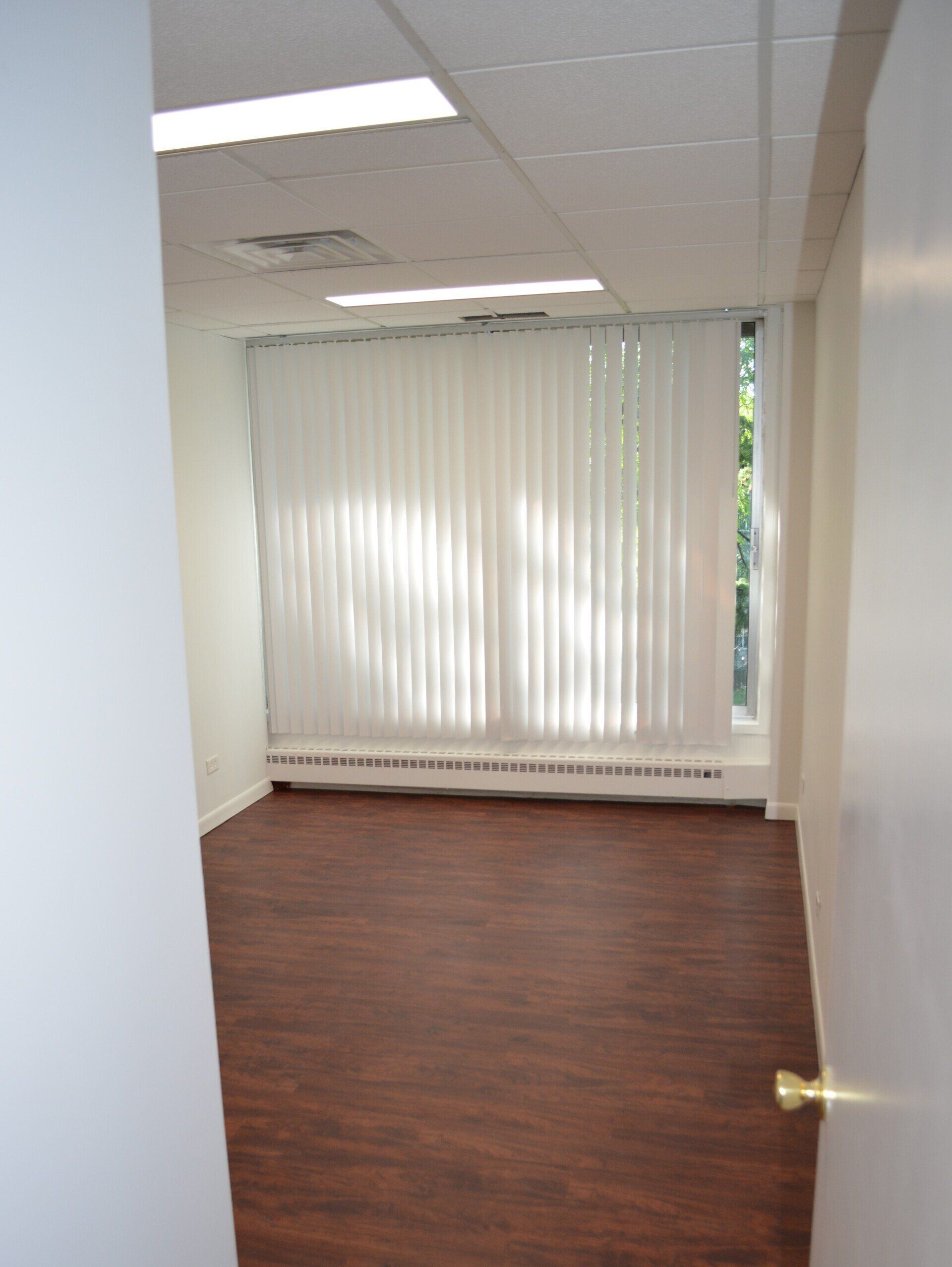 Office suite with large window and blinds