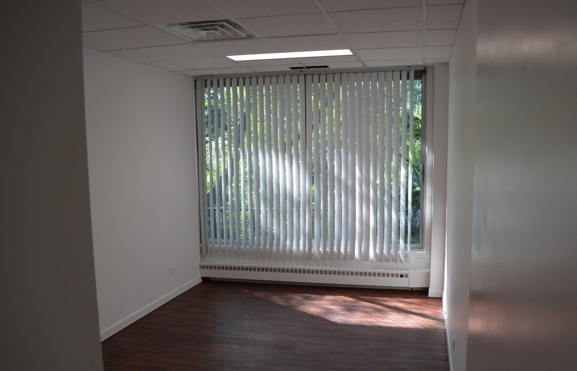 Office suite with large window and blinds