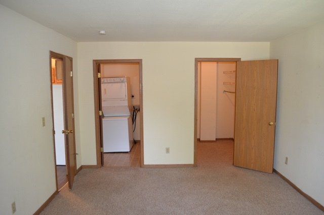 Bedroom with in-unit laundry and closet.