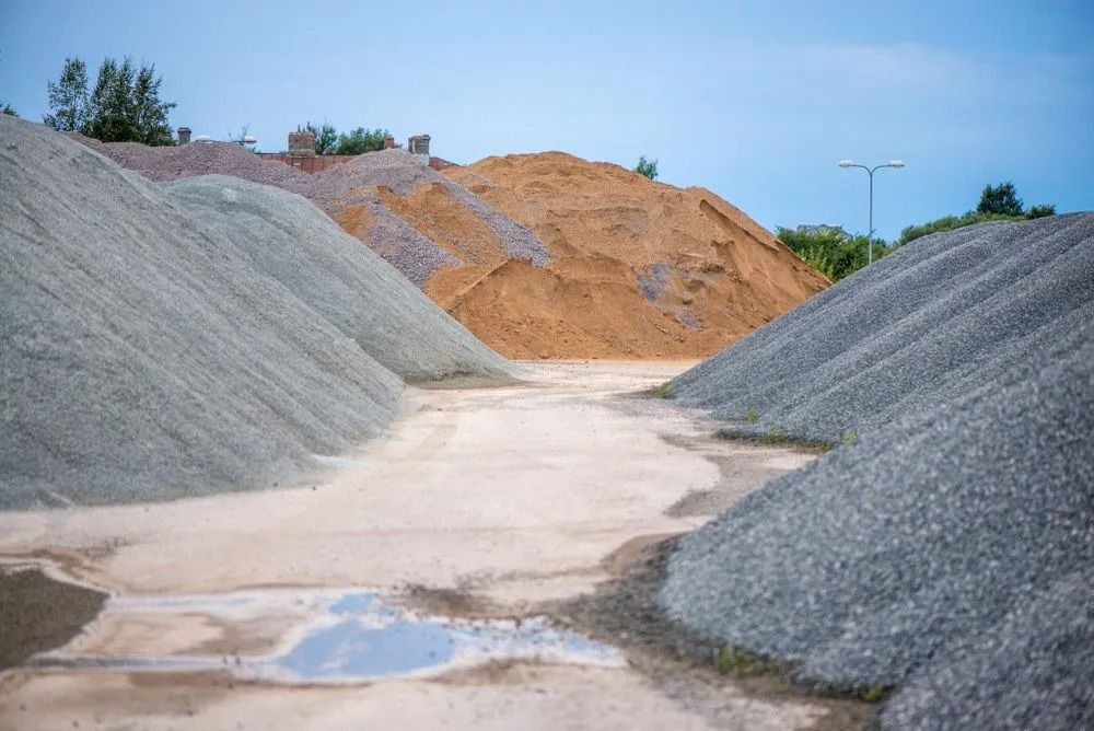 Pile of small, light gray pebbles, possibly gravel, scattered across the ground.
