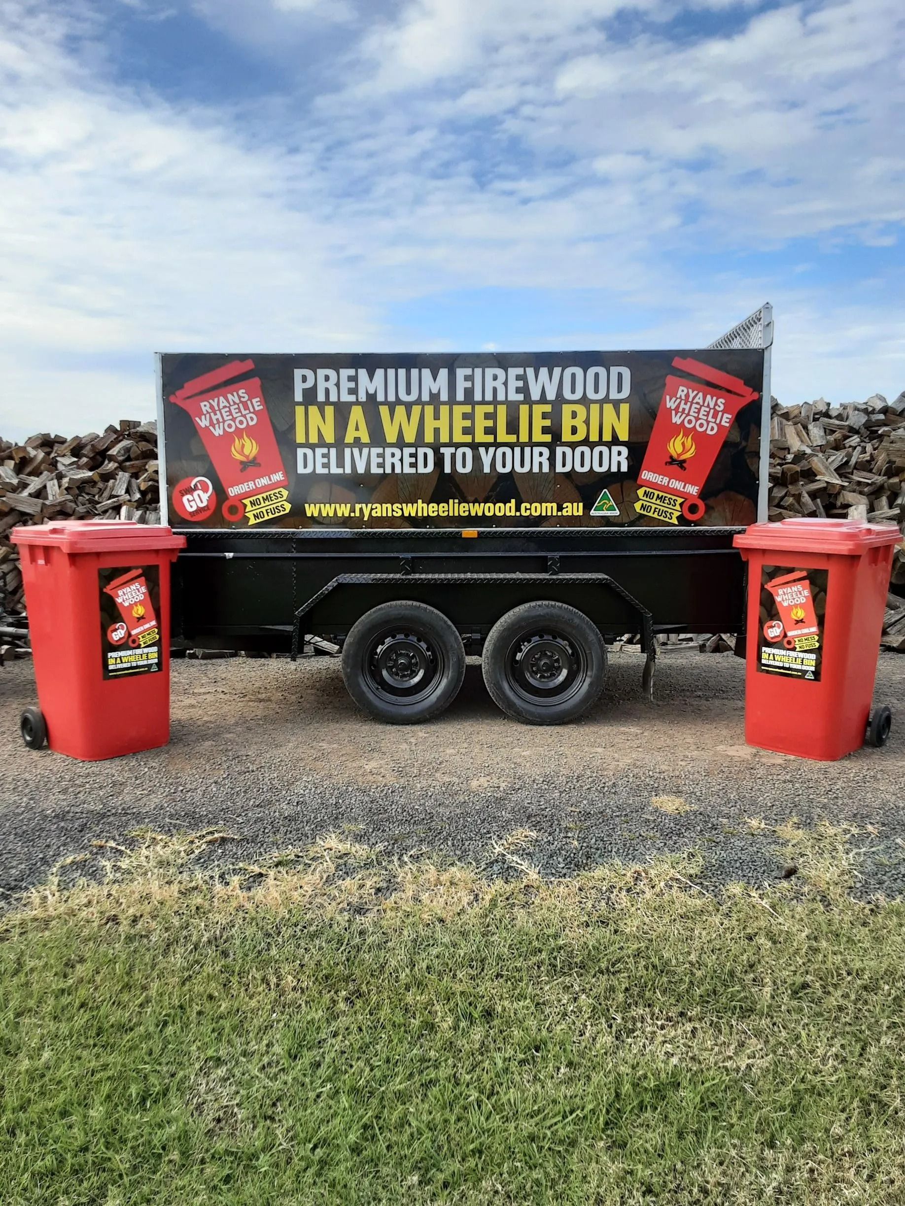 Firewood trailer: black trailer with a sign advertising 