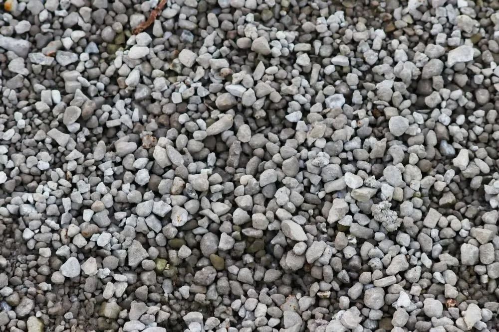 Small, gray gravel covering a surface, appearing in a dense, random pattern.