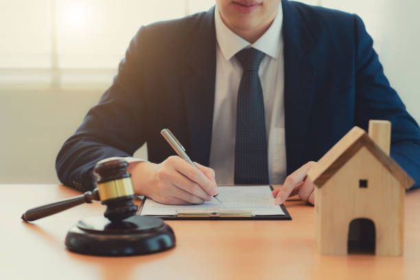 An Estate Planning Attorney from Veitengruber Law signing papers at his office in Monmouth County, N