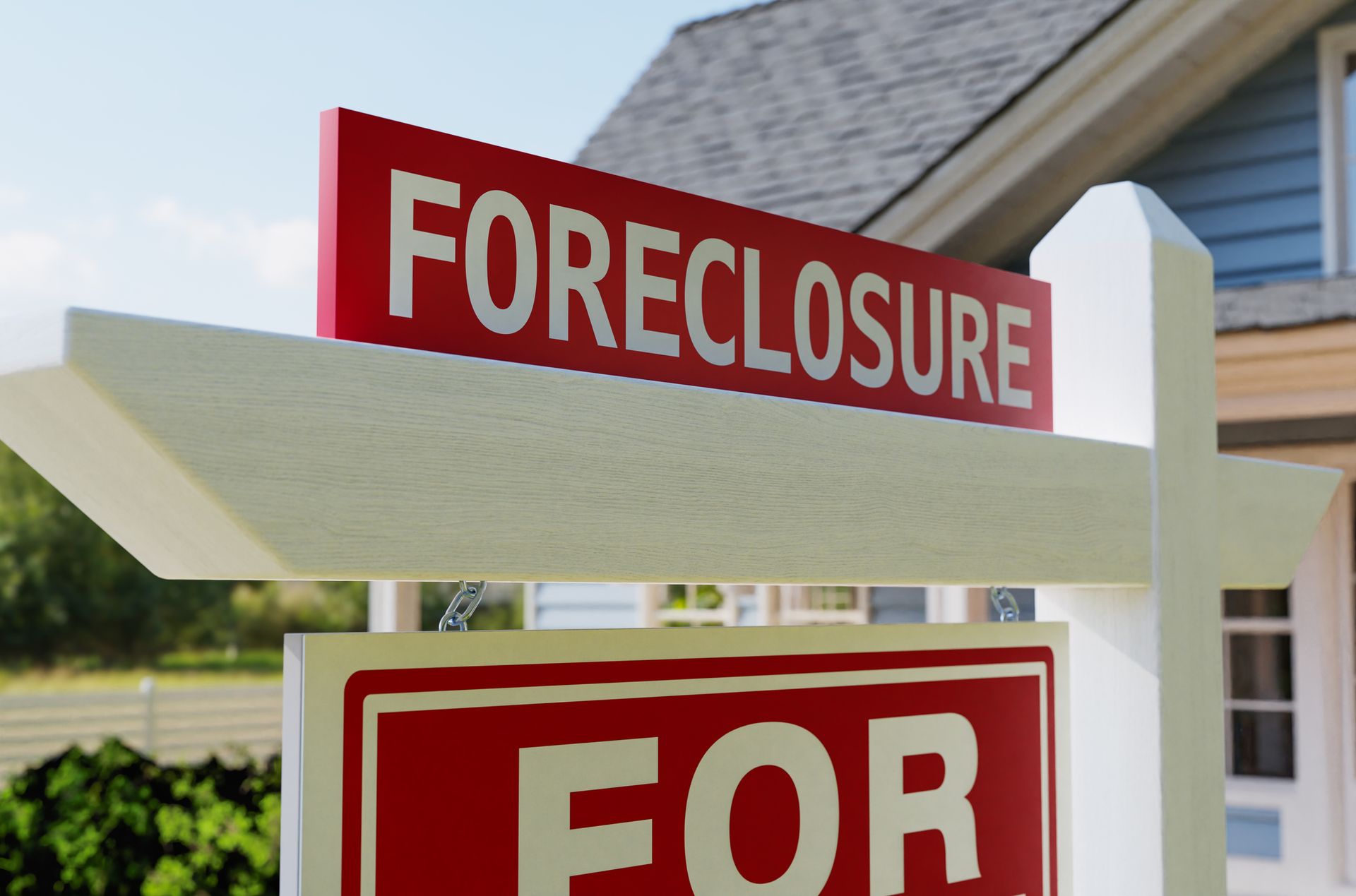 A foreclosure sign in front of a house