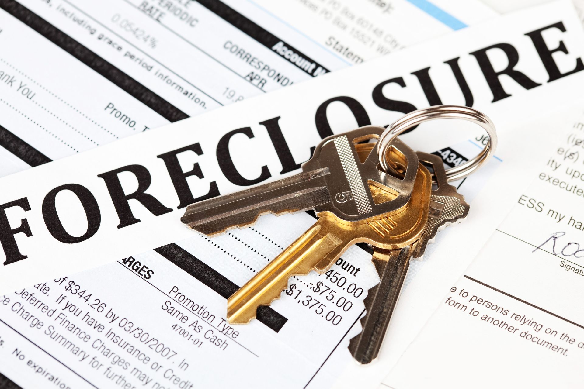 A foreclosure form with keys on top of it