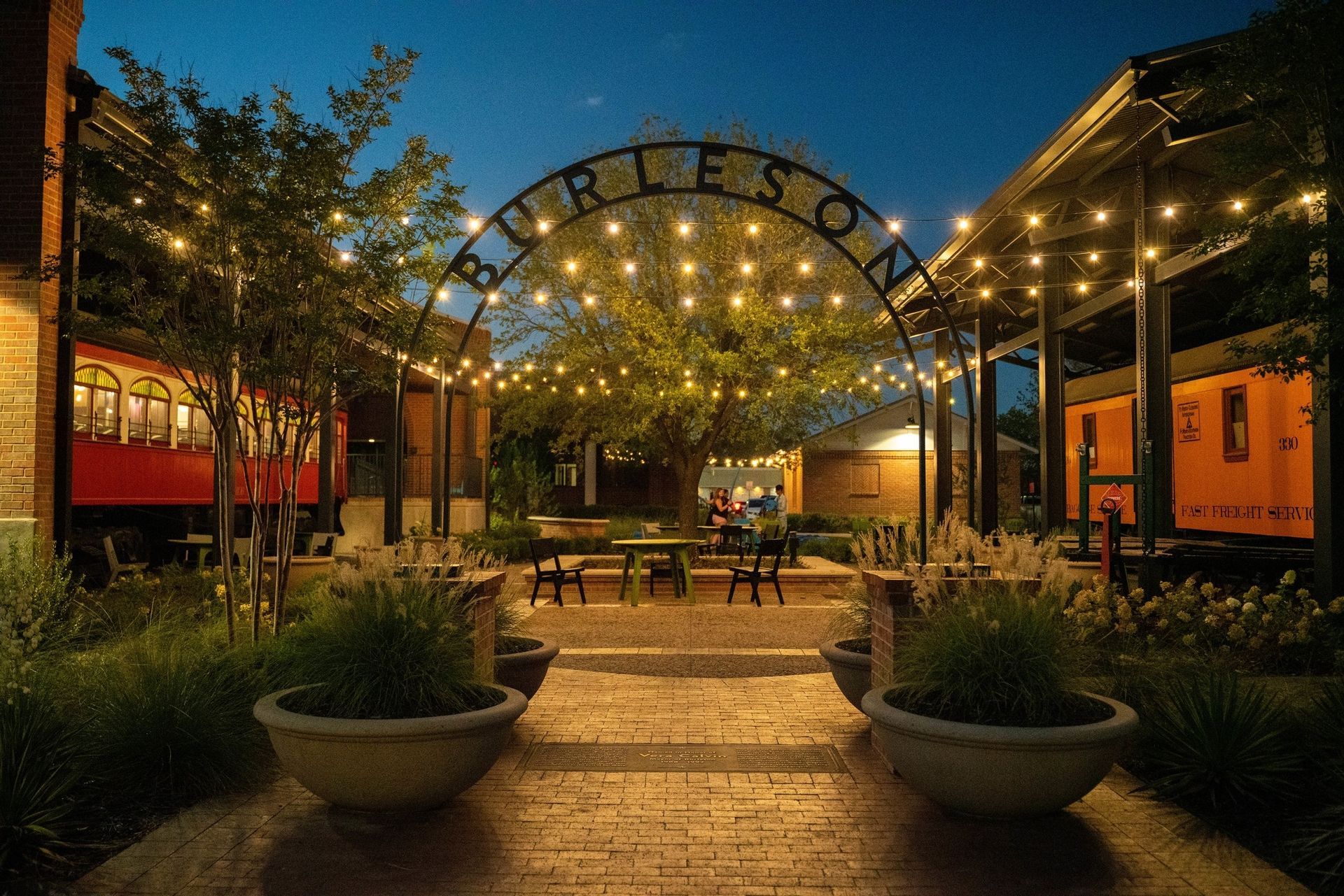 burleson town square with burleson sign leading to a sitting area