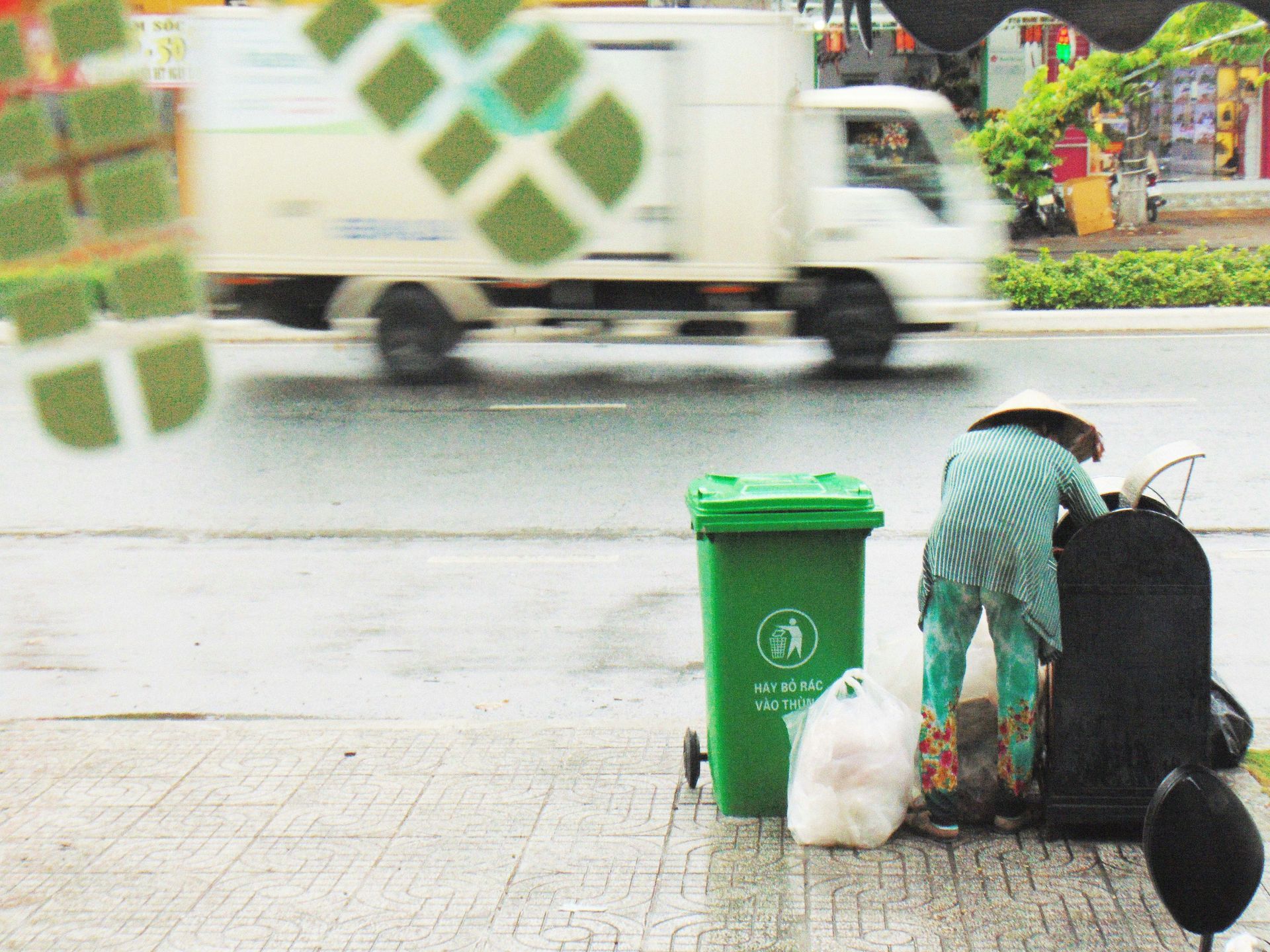 trash pickup by the side of street into green bin trash pickup by the side of street into green bin