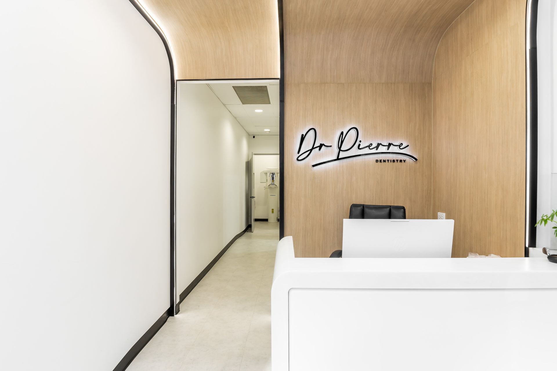 A dental office with a reception desk and a hallway.