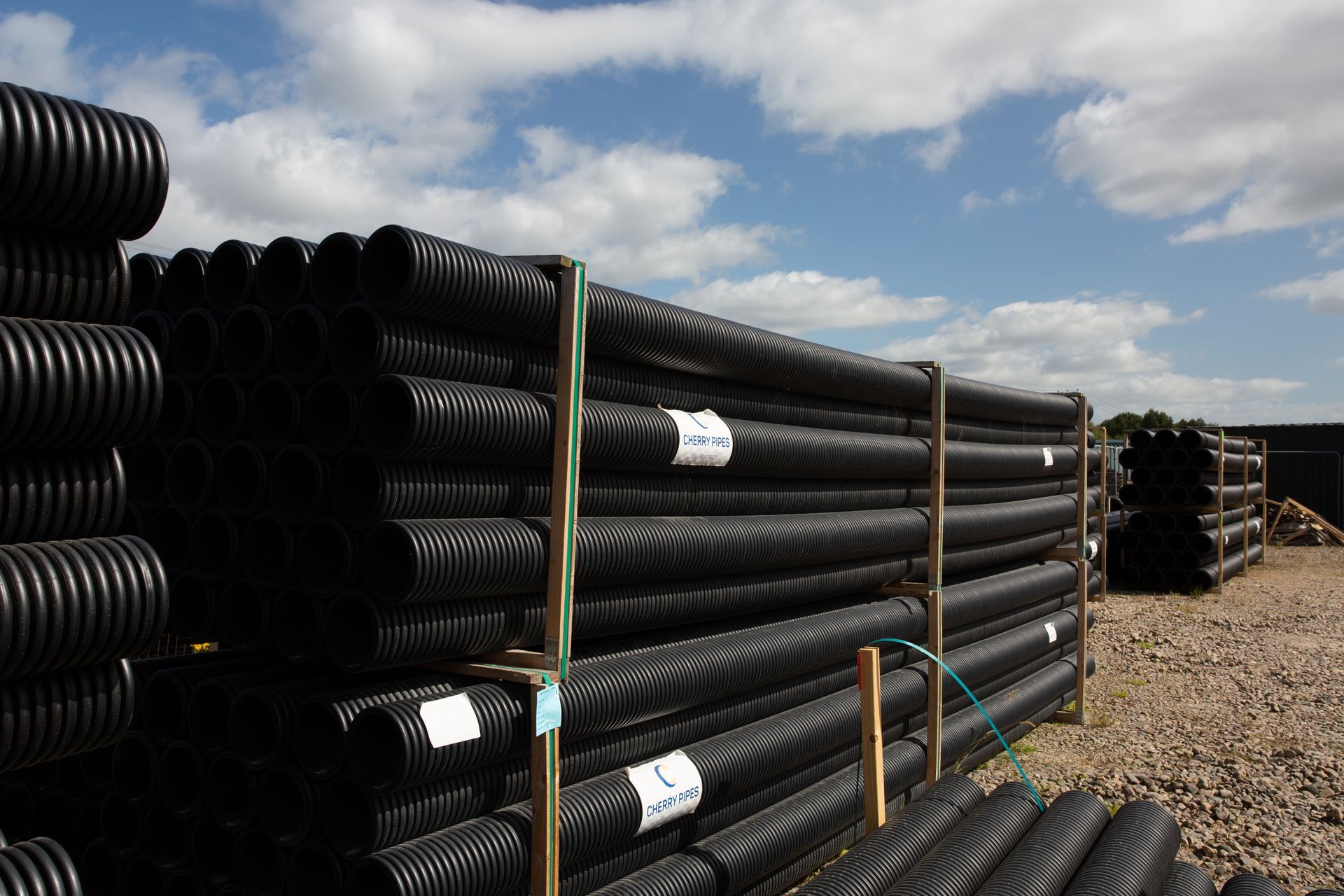 A bunch of black pipes are stacked on top of each other