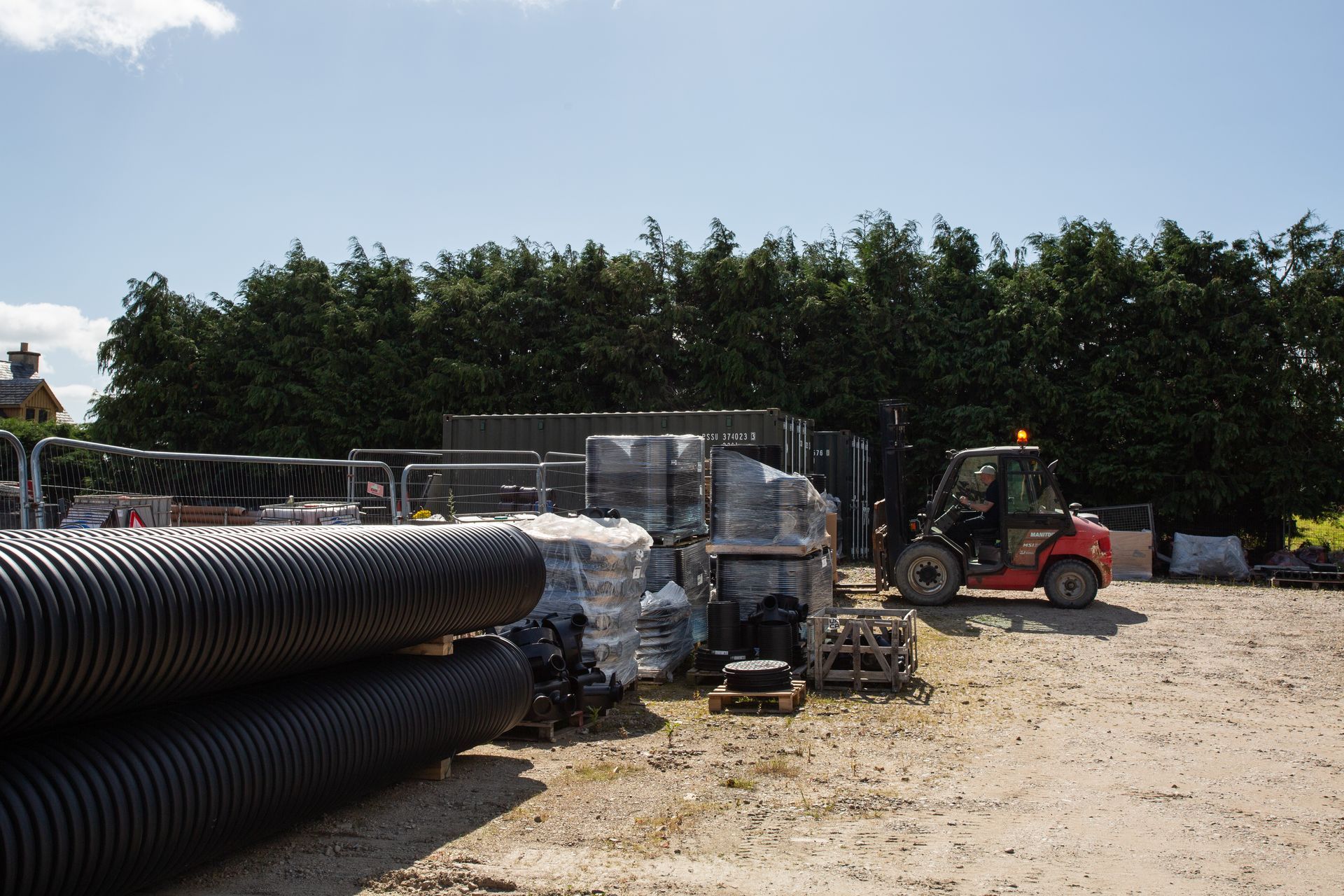 A man is driving a forklift in a construction site