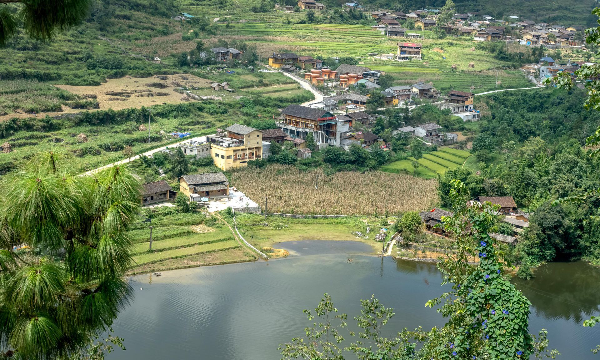 An aerial view of a construction site with a red crane.