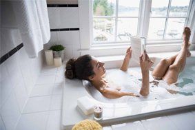 Bathroom Renovation — Woman in Bathub in Asheville, NC