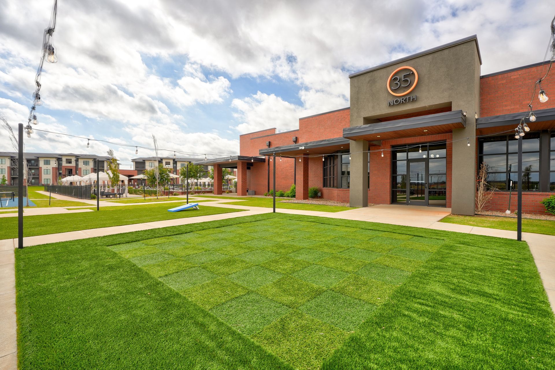 A large building with a lot of grass in front of it.
