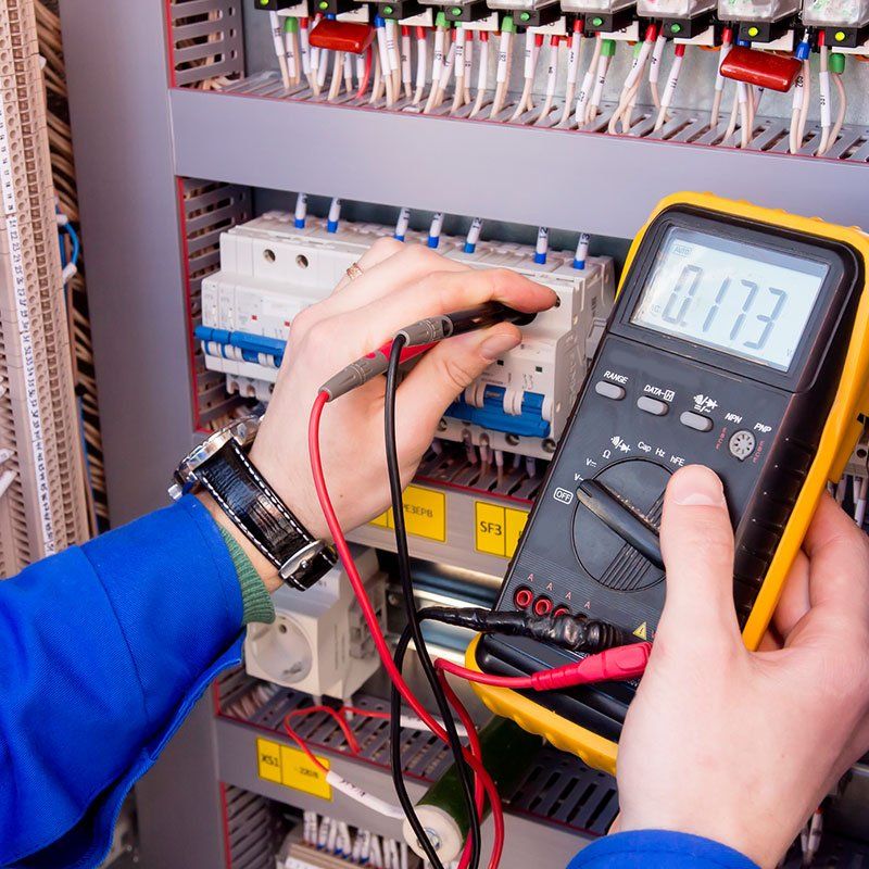 Electrician Measures Voltage of Electrical Cabinet — Chicagoland, IL — A & K Electrical Inc