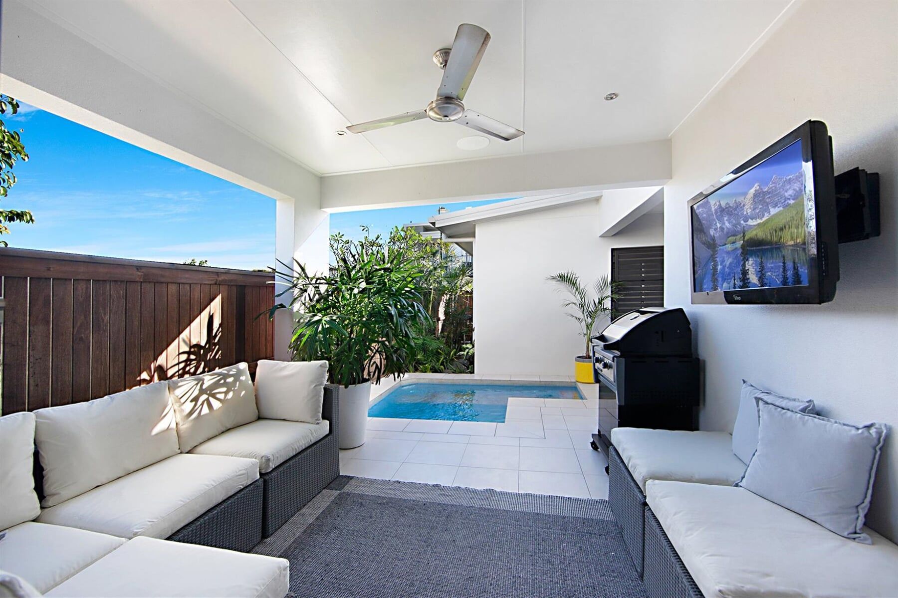 TV Outdoor Area with a Small Spa — Swimming Pools And Spas in Townsville, QLD