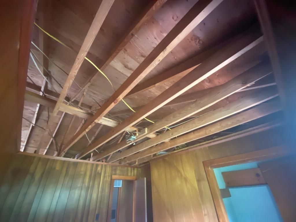 Looking up at the ceiling of a room with wood paneling