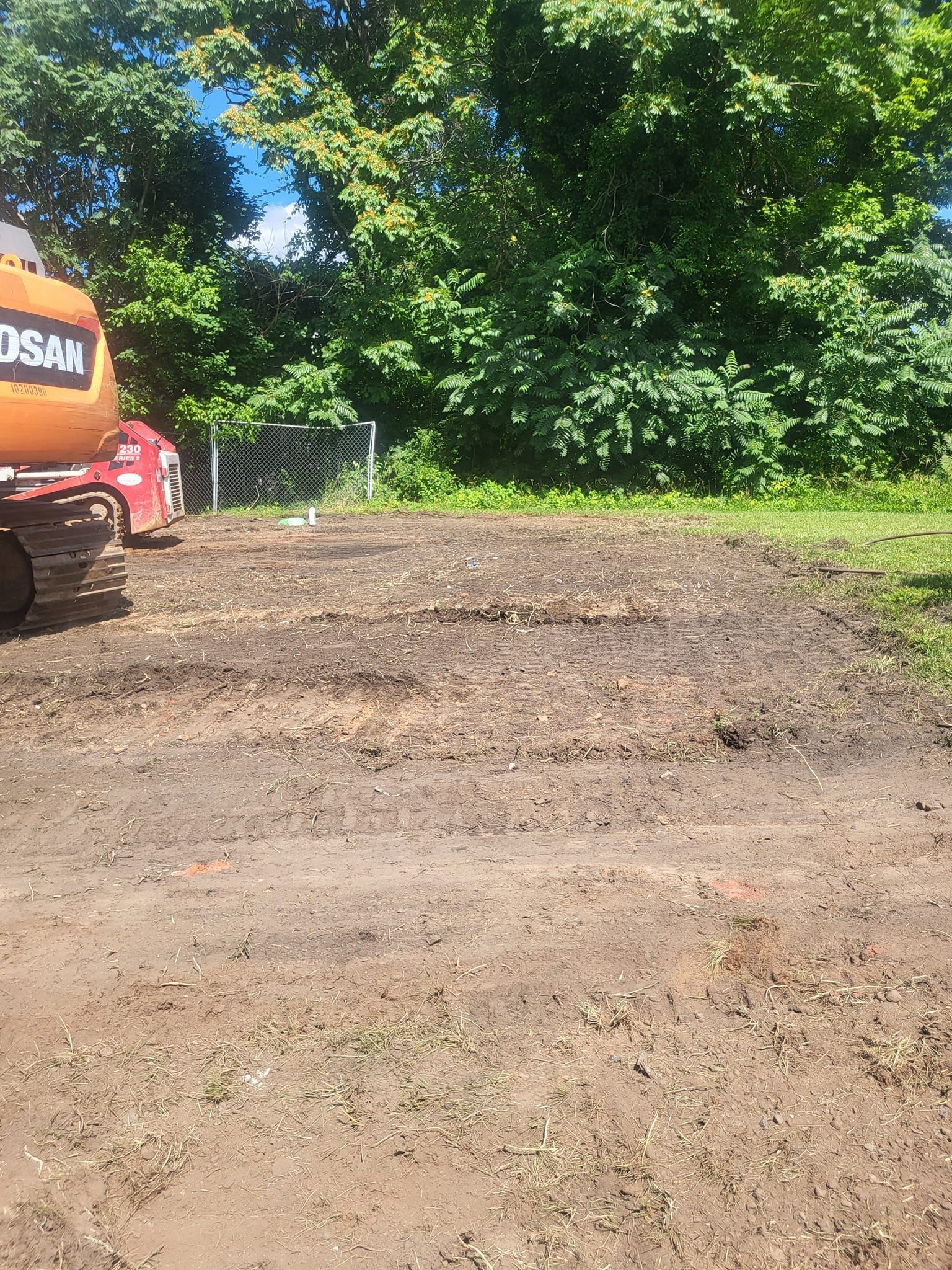 A bulldozer is sitting in the middle of a dirt road.