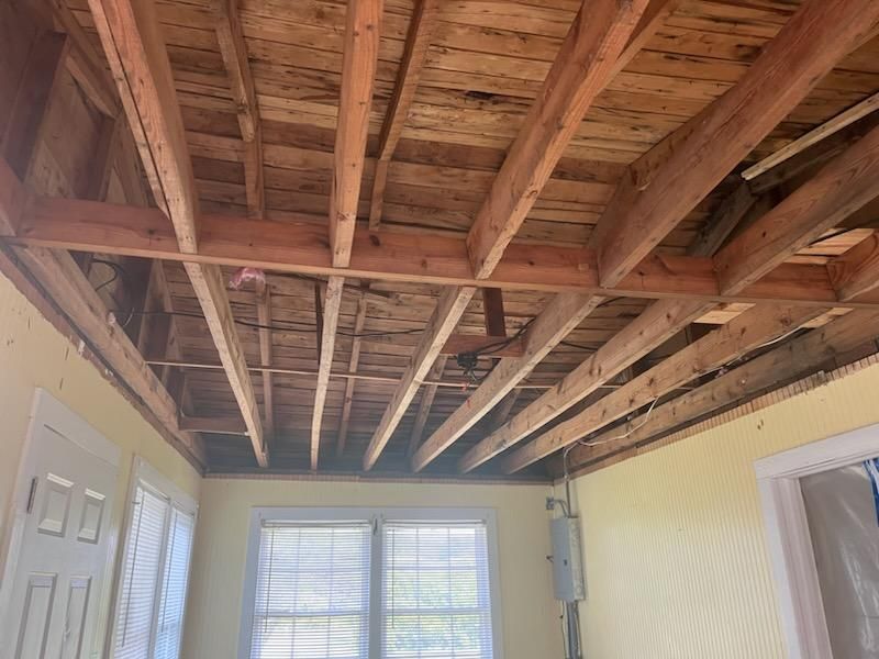 A room with a wooden ceiling and a ceiling fan.