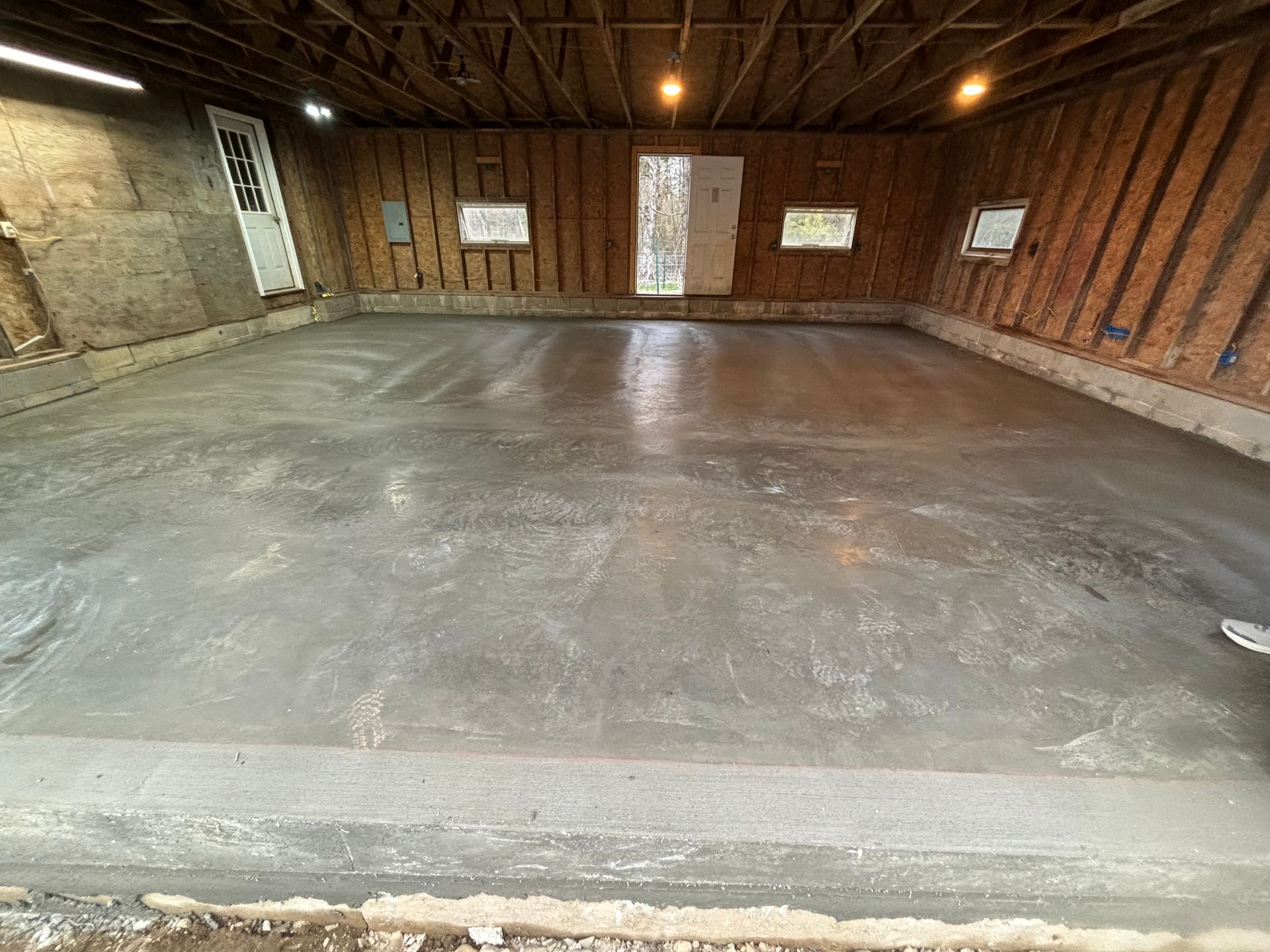 A concrete floor in a garage under construction.