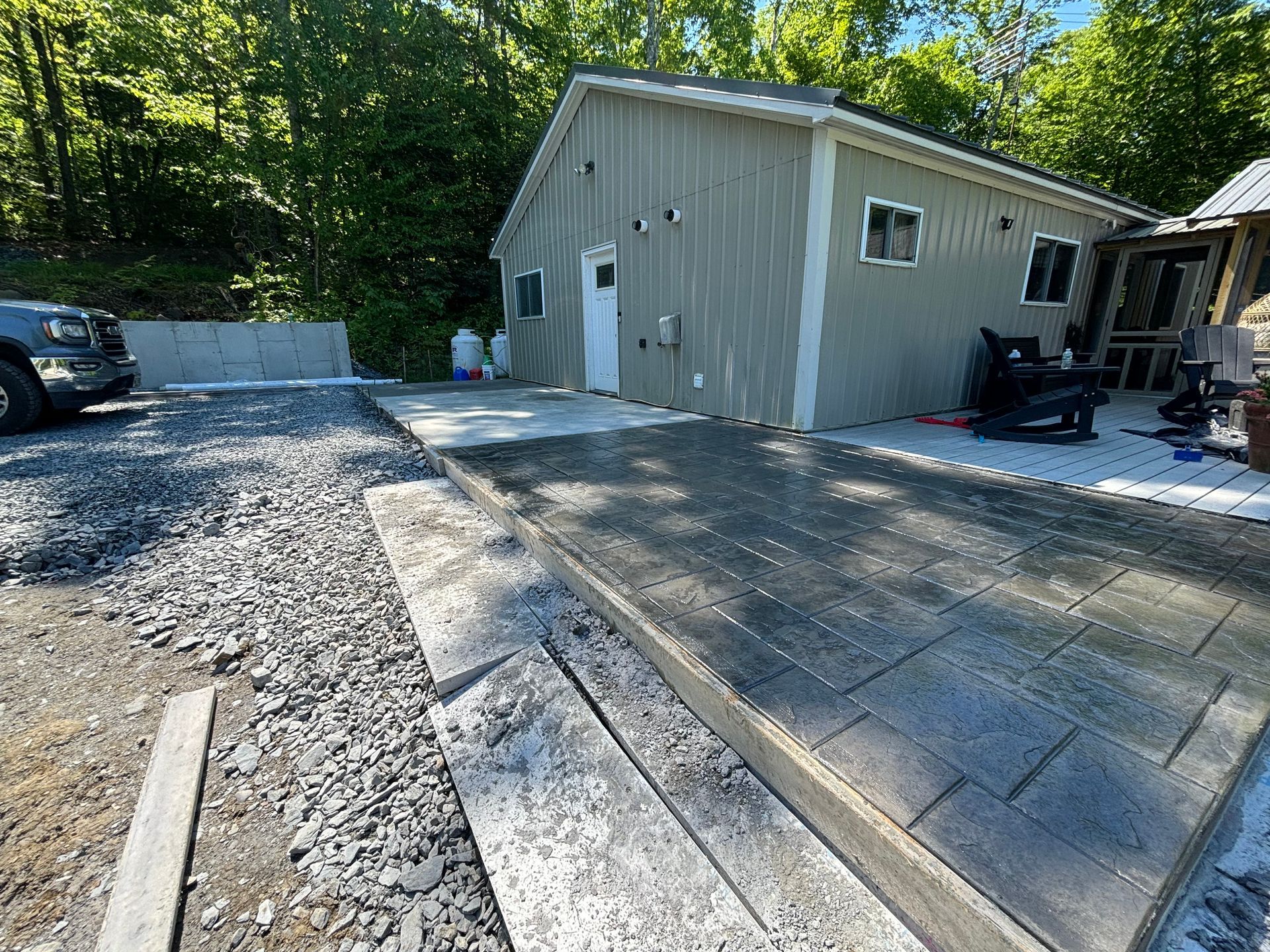 A concrete driveway is being built in front of a house.