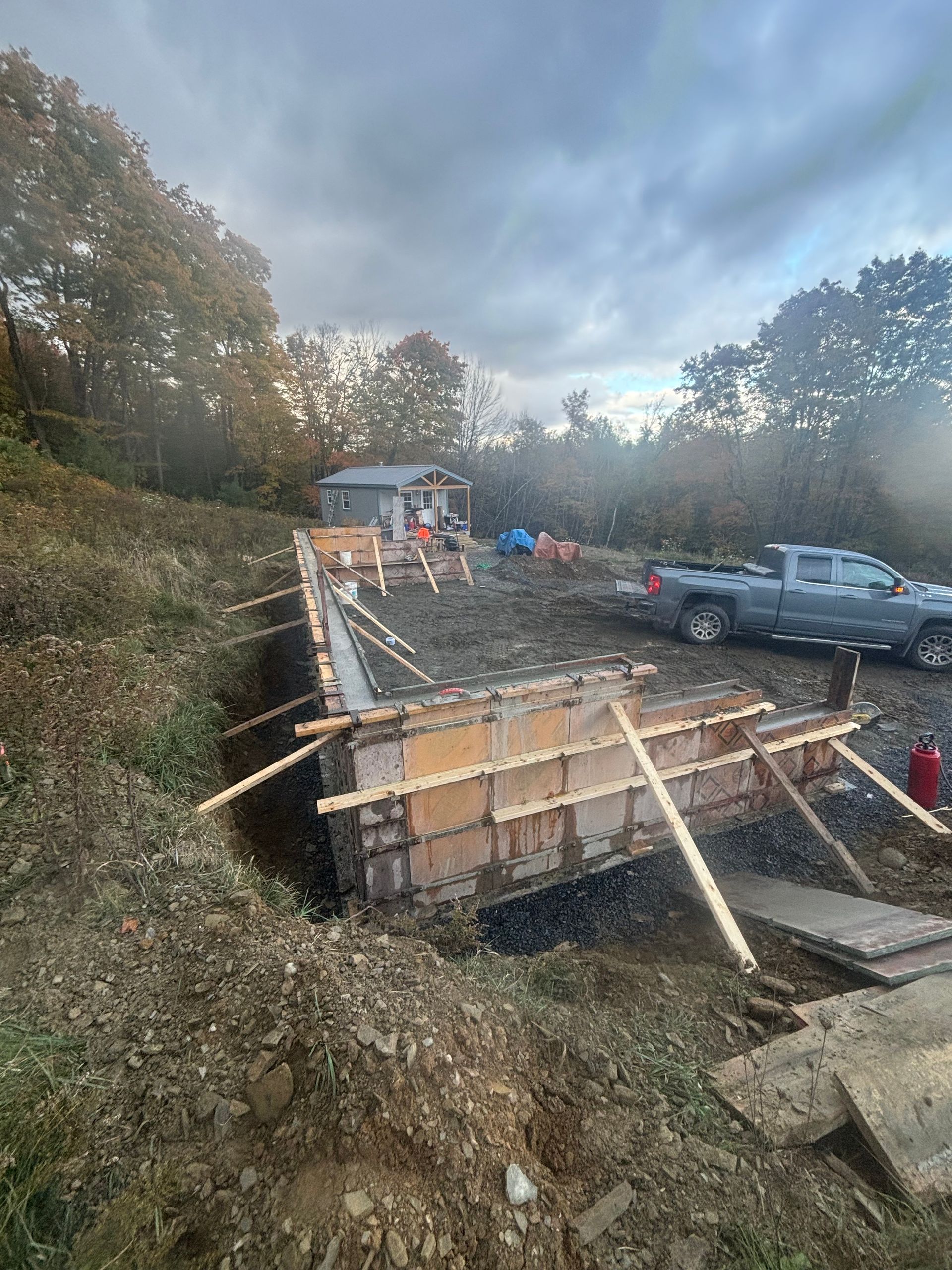 A truck is parked in front of a building under construction.