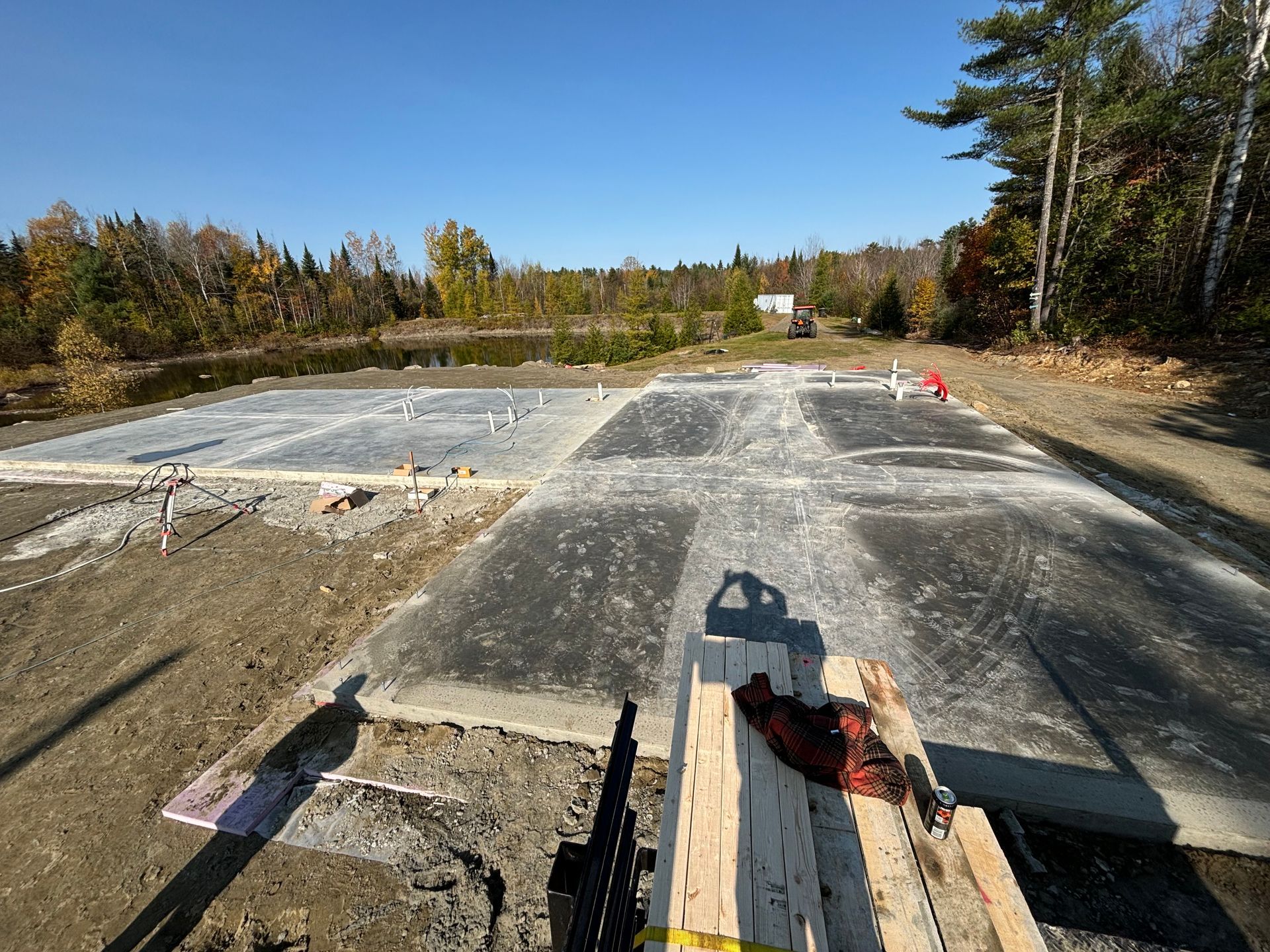 A large concrete slab is sitting on top of a dirt road.