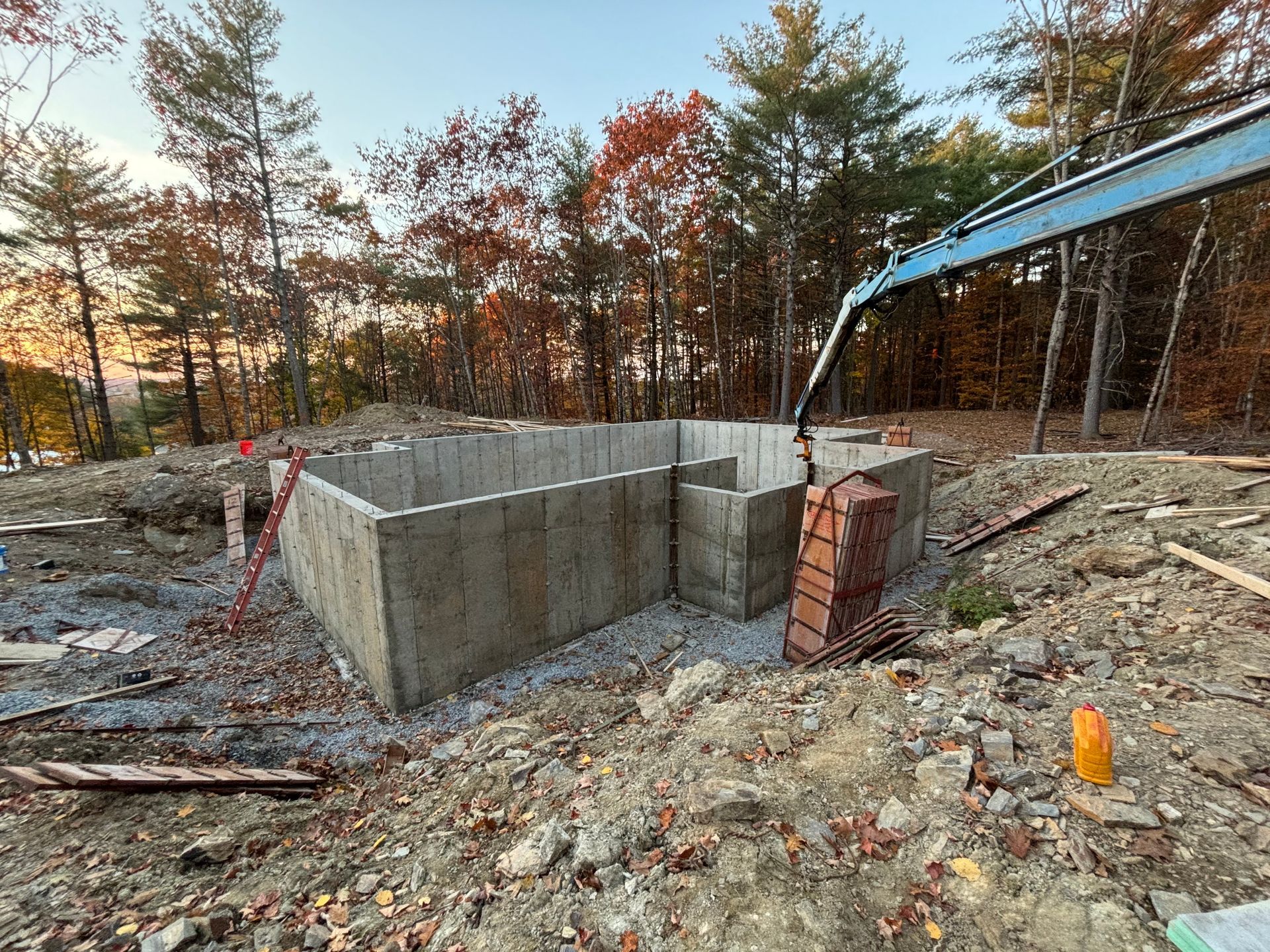A concrete foundation is being built in the middle of a forest.